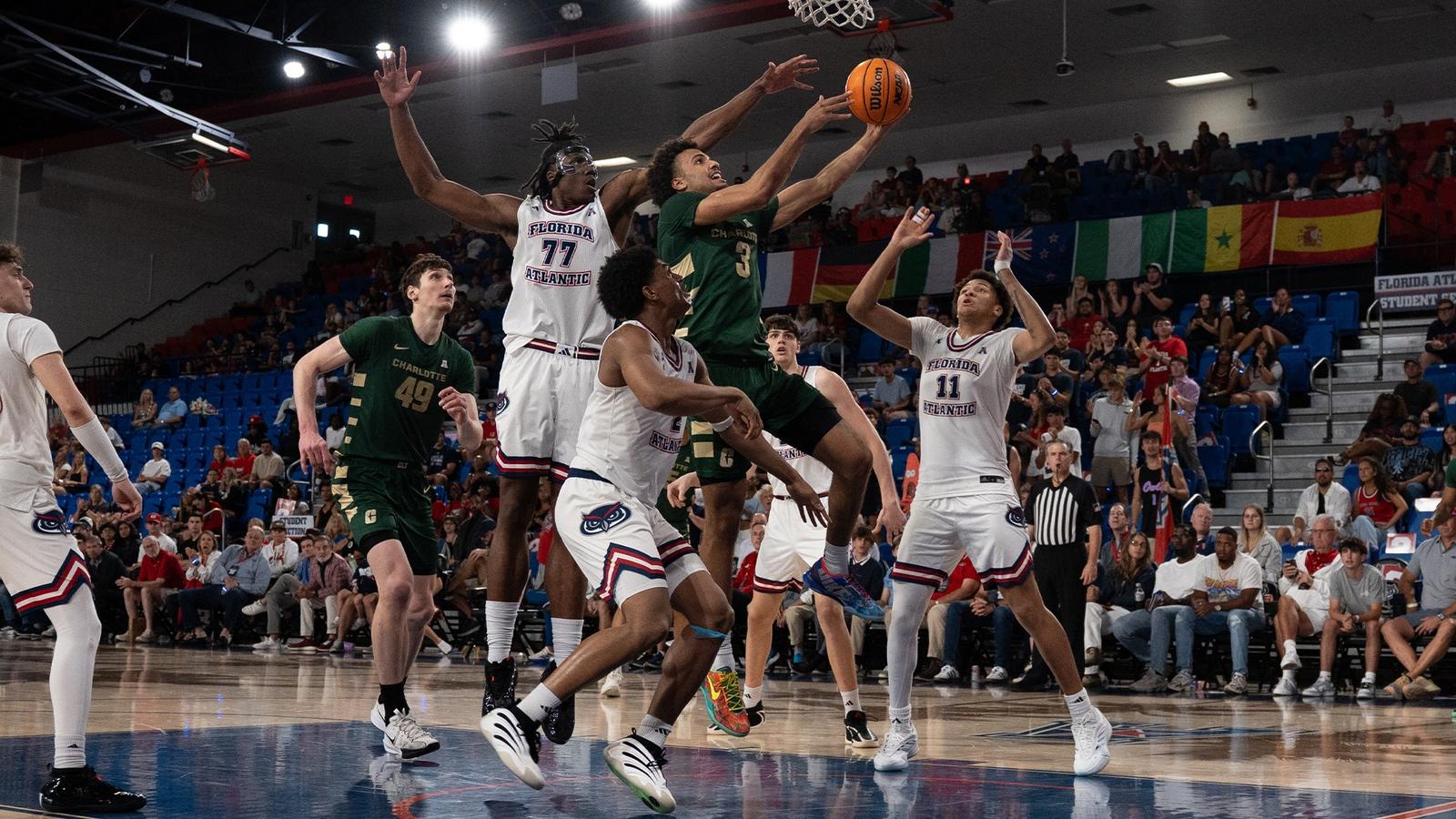 Ben Bradford drives through a group of FAU defenders