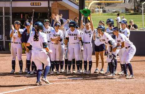 softball celebration at the plate with green hat