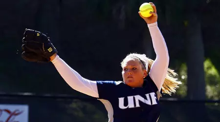 UNF softball player winding up for the pitch