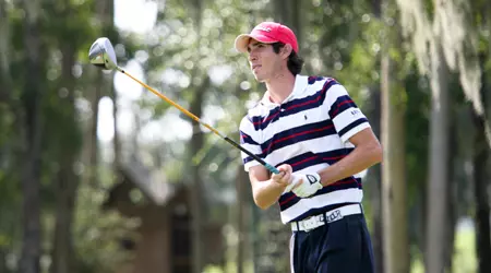 Jeff Dennis watches flight of his golf ball