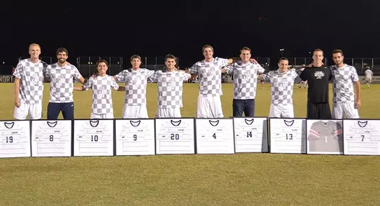 Picture of the 2015 men's soccer seniors with their framed jerseys