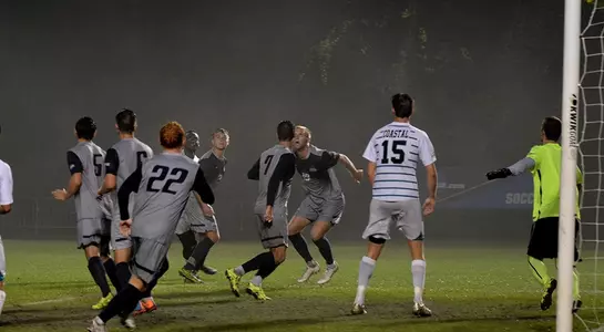 Men's soccer offense going after served ball