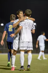 UNF men's soccer teammates congratulate each other