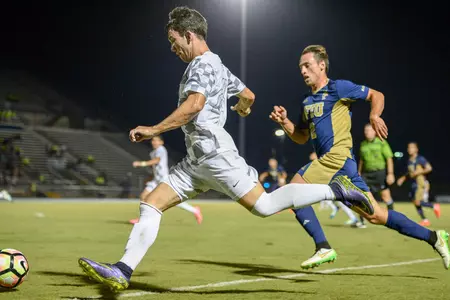 UNF men's soccer player gets ready to pass the ball