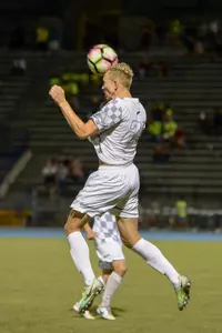 UNF men's soccer player heads the ball