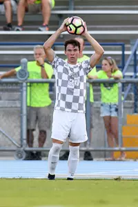 UNF men's soccer player ready to throw the ball in the game