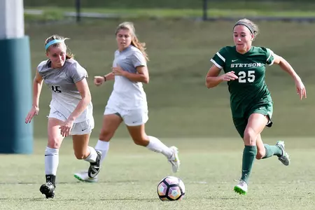 UNF women's soccer player defends against opponent