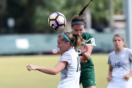 UNF women's soccer player fights for the header against opponent
