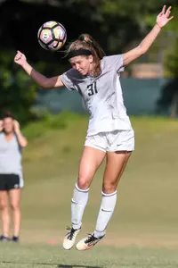 UNF women's soccer player heads the ball