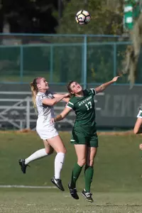 UNF women's soccer player competes for header against opponent