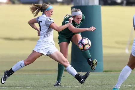 UNF Women's soccer player attempts to block the kick