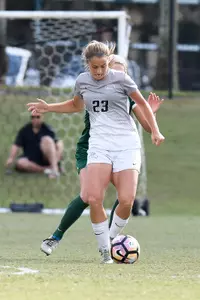 UNF women's soccer player dribbles the ball
