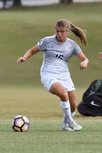 Katy Mixon traps the soccer ball.