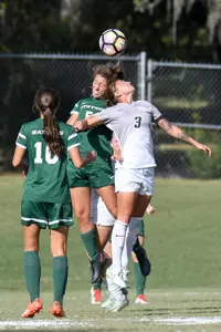 UNF women's soccer player and opponent compete for heading the ball