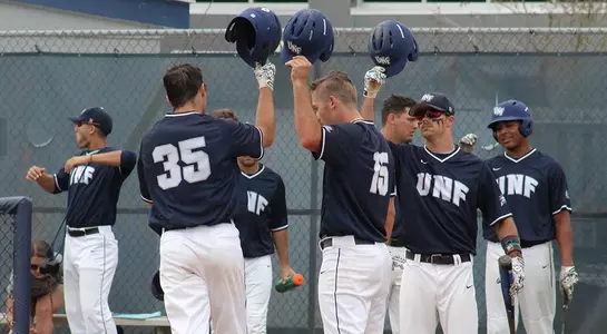 Ospreys tapping helmets at home plate after home run