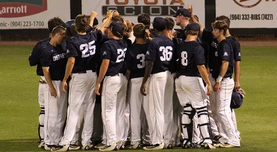 Baseball Team huddle in the outfield
