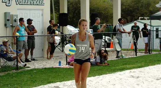 UNF beach volleyball player gets ready for the serve