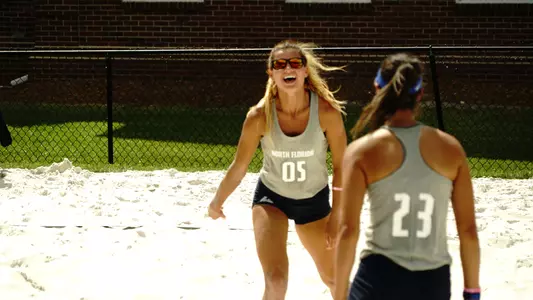 UNF beach volleyball players cheer for point