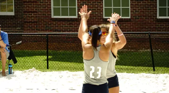 UNF volleyball players high-five each other