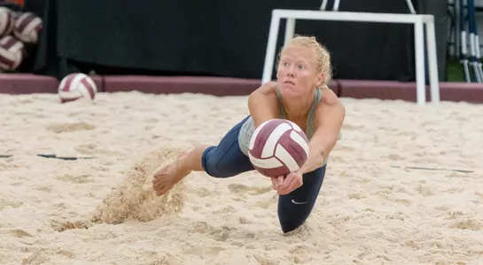 UNF volleyball player dives for the pass