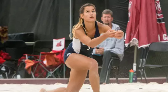 UNF beach volleyball player gets ready to dive for the pass