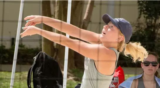 UNF beach volleyball player passes the ball