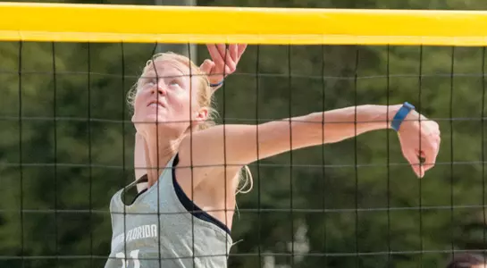 UNF beach volleyball player eyes the ball for a spike