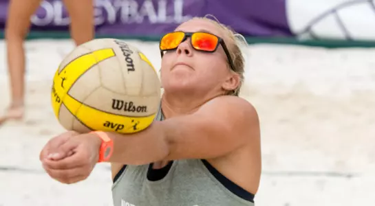 UNF beach volleyball player passes the ball