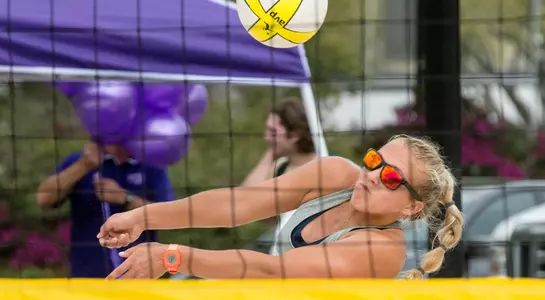UNF beach volleyball player makes a bump pass