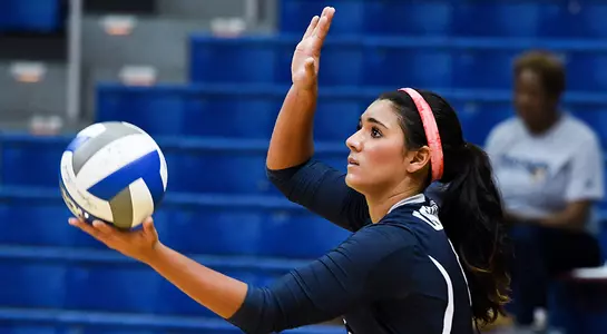 UNF volleyball player prepares to serve the ball
