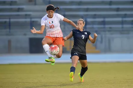 UNF women's soccer player jumps for a volley of the ball