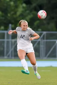 UNF women's soccer player strikes the ball