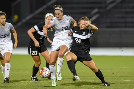 UNF women's soccer player fights to maintain possession against opponent