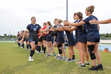 UNF women's soccer team with each other good luck before the game