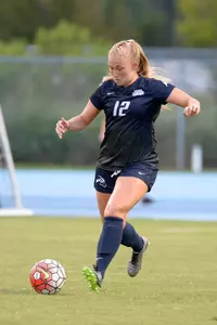 UNF women's soccer player strikes the ball