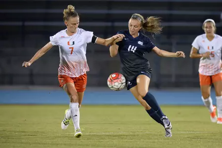 UNF women's soccer player dribbles against opponent