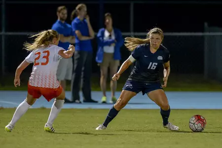 UNF women's soccer player attempts to shake opponent with a dribble