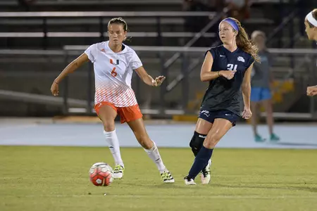 UNF women's soccer player makes a pass to teammate