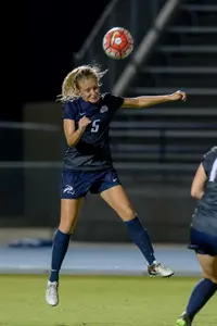 UNF women's soccer player heads the ball