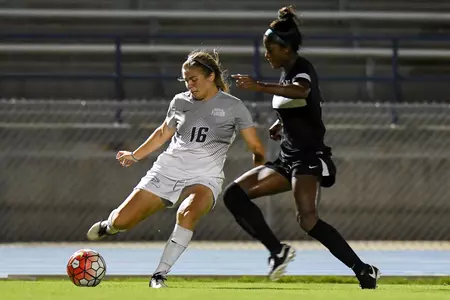 UNF women's soccer player get's ready to strike the ball against an opponent