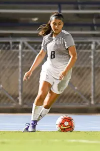 UNF women's soccer player dribbles the ball up field