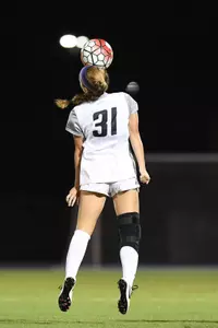UNF women's soccer player chests the ball