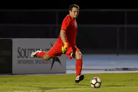 UNF men's soccer goalie kicks the ball