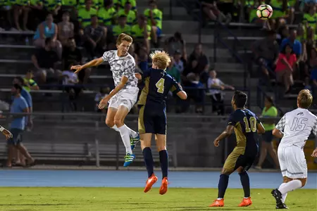 UNF men's soccer makes a header pass to teammate