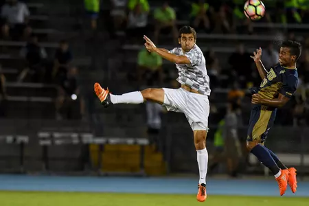 UNF men's soccer player makes a jump kick