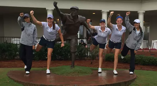 Women's golf team poses with Payne Stewart statue at Pinehurst Resort Course No. 1