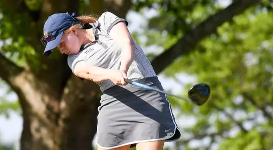 Teresa Conroy completes a swing on the tee box