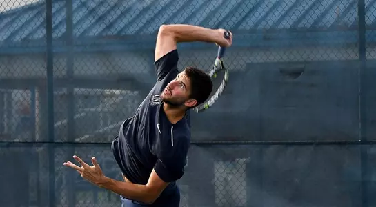 Jefta Kecic serves the tennis ball.