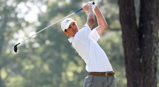 Travis Trace finishes his swing on course