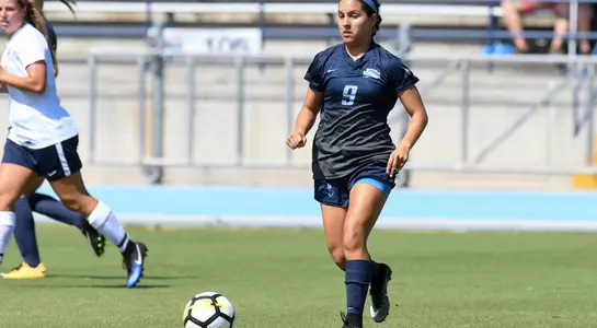 Lisa Cedeno follows the soccer ball.